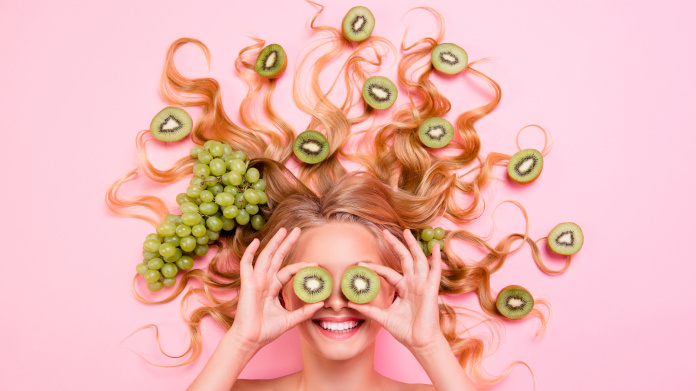 Donna sorridente con cibo antiossidante tra i capelli