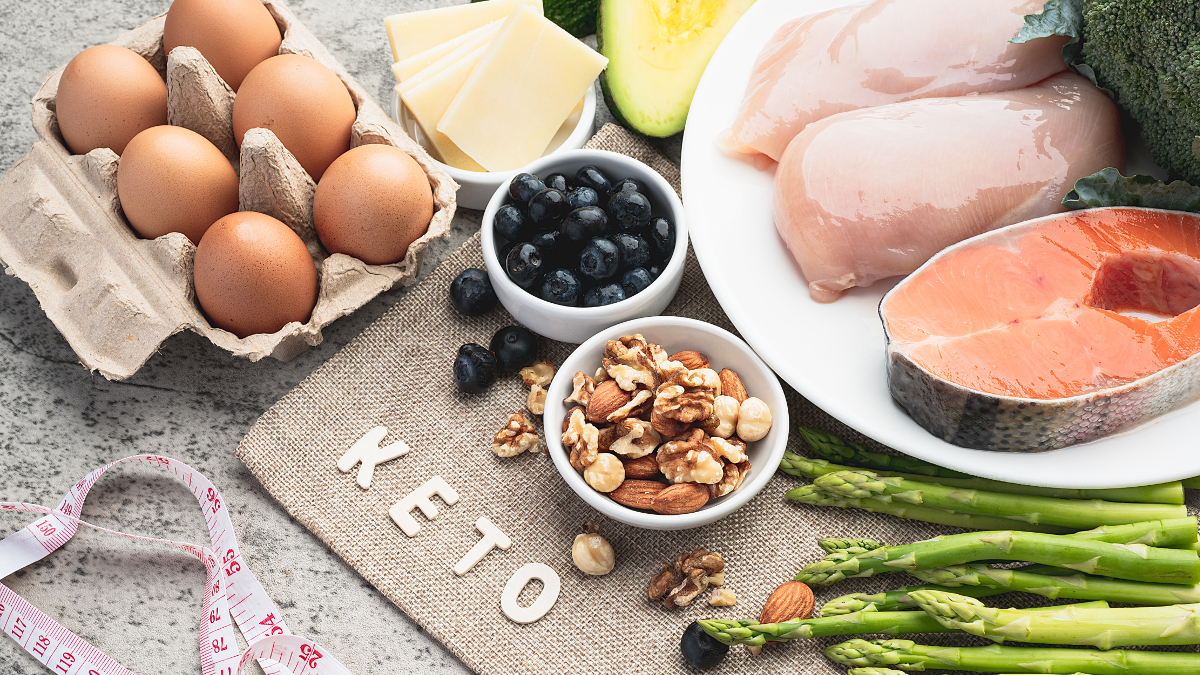 Ketogene Ernährung mit Fleisch, Fisch, Eiern, Avocados und das Wort Keto